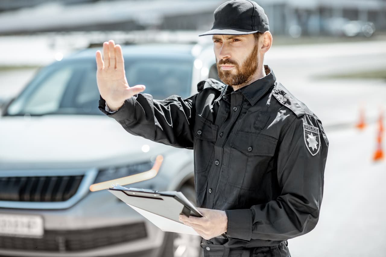 Un agent de police vérifiant le contrat d'assurance d'une conductrice.